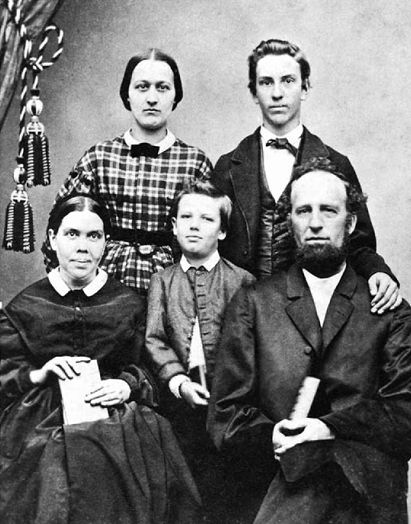 Family portrait photograph showing the White family and Adelia P. Patten, with Willie between his parents and Edson standing in the rear